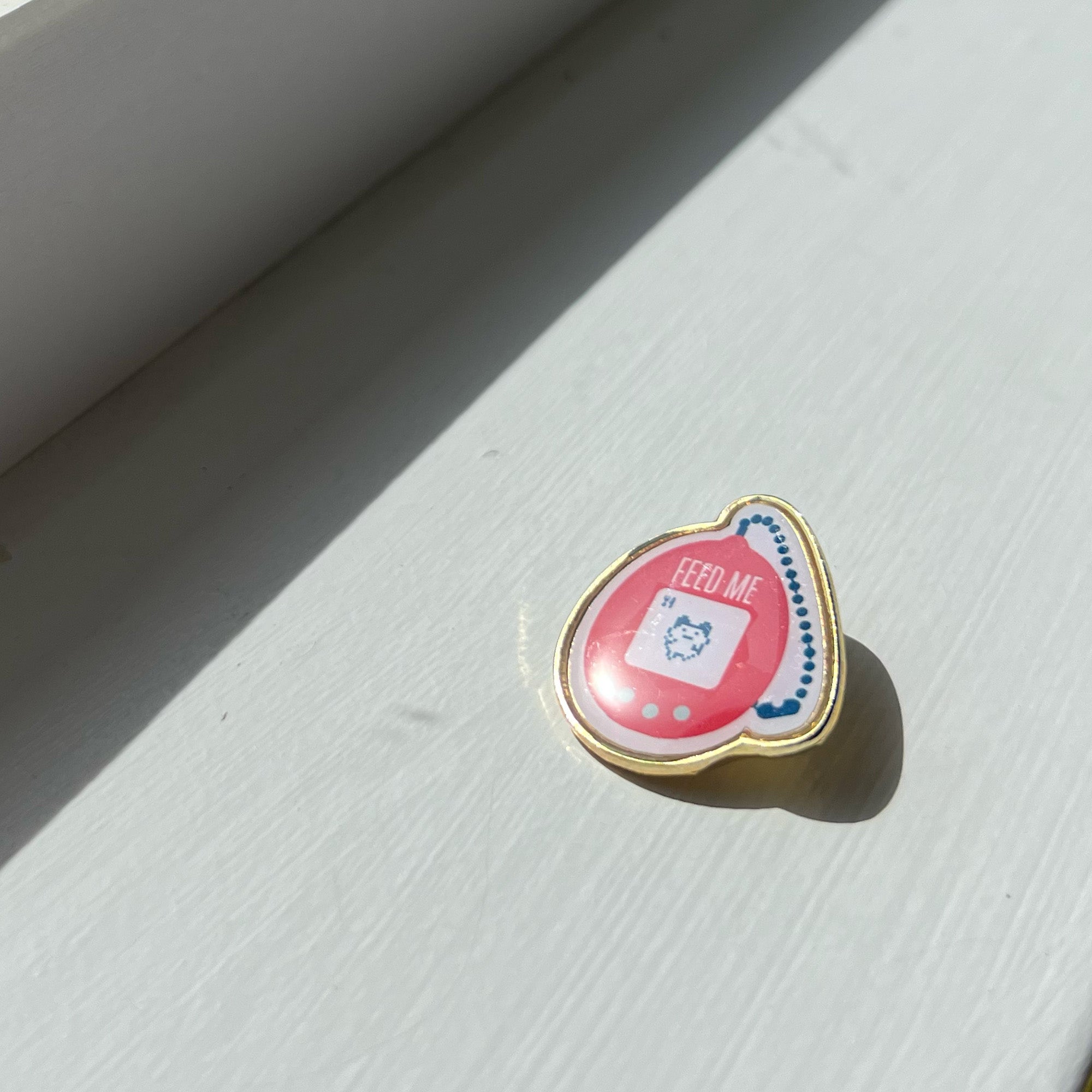 Feed me tamagotchi lapel pin by I&