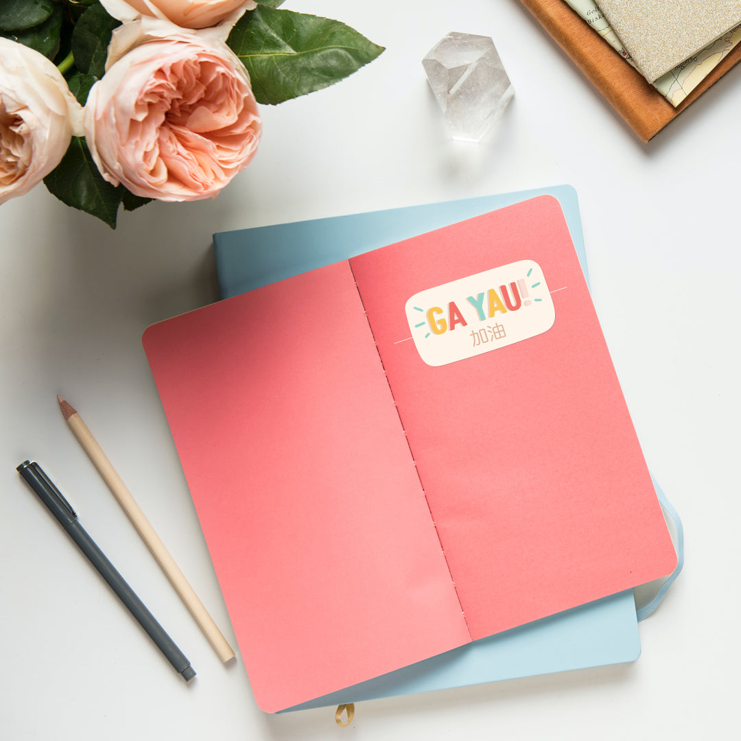 Ga Yau 加油 vinyl sticker on notebook