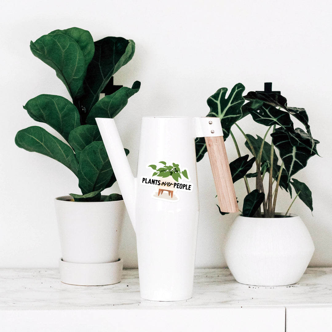 Plants over people vinyl sticker on white watering can