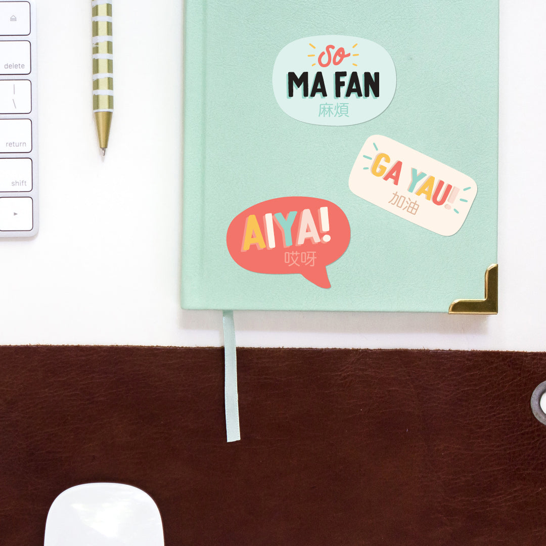 Ga Yau 加油 vinyl sticker, Aiya 哎呀 vinyl sticker, So ma fan 麻煩 vinyl sticker on notebook